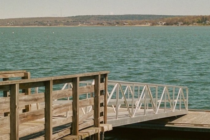 a wooden pier next to a body of water