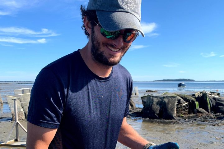 a man standing next to a body of water