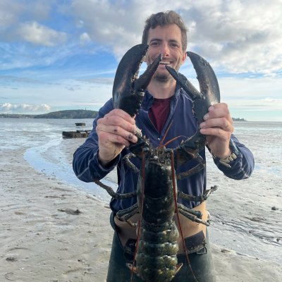 a man standing next to a body of water