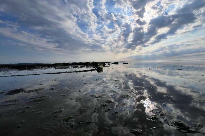 a group of clouds in the sky over a body of water