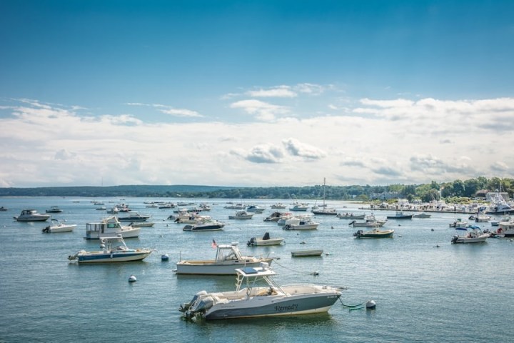 a small boat in a harbor next to a body of water