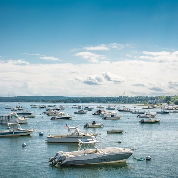 a small boat in a harbor next to a body of water